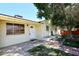Home exterior featuring a mature tree, seating area, and convenient backyard access at 2614 W Greenway Rd, Tempe, AZ 85282