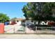 Charming single-story home featuring a secure white fence and mature landscaping at 2614 W Greenway Rd, Tempe, AZ 85282