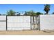 Rustic white wooden and iron gate in a backyard setting, adding a touch of charm at 2614 W Greenway Rd, Tempe, AZ 85282