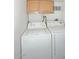 Washer and dryer in the laundry room with overhead cabinets for storage at 2614 W Greenway Rd, Tempe, AZ 85282