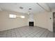 Open living room with tile flooring, fireplace and windows, providing a well-lit space at 2614 W Greenway Rd, Tempe, AZ 85282