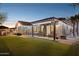 Expansive backyard with artificial grass, patio, greenhouse, and stylish exterior lighting, perfect for entertaining at 263 S Del Rancho --, Mesa, AZ 85208