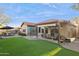 Well-manicured backyard with green artificial turf, patio, sitting area and a small greenhouse at 263 S Del Rancho --, Mesa, AZ 85208