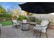 Inviting backyard space with brick pavers, a cozy fire pit, comfortable seating, and lush landscaping at 263 S Del Rancho --, Mesa, AZ 85208