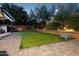 Serene backyard with artificial grass, brick accents, soft landscape lighting, and a decorative turtle accent at 263 S Del Rancho --, Mesa, AZ 85208