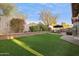 Spacious backyard featuring artificial turf, a brick wall, and ample greenery, creating a private outdoor oasis at 263 S Del Rancho --, Mesa, AZ 85208