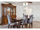The dining room features tile floors, arched doorway, a wooden table with patterned chairs, and a china cabinet at 263 S Del Rancho --, Mesa, AZ 85208