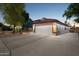Side view of the house featuring a two-car garage, concrete driveway and tile roof with updated lighting at 263 S Del Rancho --, Mesa, AZ 85208