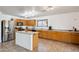 Well-lit kitchen with oak cabinets, a center island, tile flooring, and stainless steel appliances at 263 S Del Rancho --, Mesa, AZ 85208