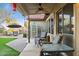 Covered patio offers outdoor seating with ceiling fan and views of the landscaped backyard with a greenhouse at 263 S Del Rancho --, Mesa, AZ 85208