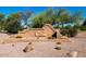 Community entrance featuring the Signal Butte Ranch sign, stone details and desert landscaping at 263 S Del Rancho --, Mesa, AZ 85208