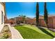 Lush backyard features a putting green and covered outdoor seating area, perfect for entertaining at 2731 E Cherry Hill Dr, Gilbert, AZ 85298