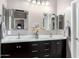This bathroom features a double vanity with dark wood cabinets and modern hardware at 2731 E Cherry Hill Dr, Gilbert, AZ 85298