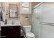 This bathroom features a single vanity with a dark wood cabinet and a shower with glass doors at 2731 E Cherry Hill Dr, Gilbert, AZ 85298