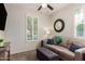 This bedroom features a ceiling fan, a neutral-colored sofa, and plantation shutters at 2731 E Cherry Hill Dr, Gilbert, AZ 85298