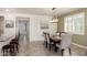 Dining room featuring a modern light fixture, a rectangular wooden table with six chairs, and a large window at 2731 E Cherry Hill Dr, Gilbert, AZ 85298