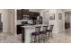 Modern kitchen features a large island with seating, stainless steel appliances, and dark wood cabinets at 2731 E Cherry Hill Dr, Gilbert, AZ 85298