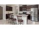 Modern kitchen features a large island with seating, stainless steel appliances, and dark wood cabinets at 2731 E Cherry Hill Dr, Gilbert, AZ 85298