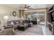 Comfortable living room with a sectional sofa, ceiling fan, and sliding glass doors leading to the patio at 2731 E Cherry Hill Dr, Gilbert, AZ 85298