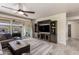 Living room with patio access, featuring a ceiling fan and a built-in entertainment center at 2731 E Cherry Hill Dr, Gilbert, AZ 85298
