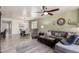 Open living room and dining area featuring modern decor, a ceiling fan, and tile flooring at 2731 E Cherry Hill Dr, Gilbert, AZ 85298
