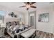 This bedroom features a ceiling fan, wood-look floors, and an ensuite bathroom at 2731 E Cherry Hill Dr, Gilbert, AZ 85298