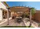 Inviting outdoor dining area under a pergola, ideal for al fresco meals and gatherings at 2731 E Cherry Hill Dr, Gilbert, AZ 85298