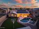 Sunset aerial view of the house highlighting a private pool and lush backyard with a basketball court at 29227 N 44Th St, Cave Creek, AZ 85331