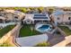 Aerial view of backyard with pool, basketball court, and grassy area, complimented by solar panels at 29227 N 44Th St, Cave Creek, AZ 85331
