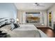 Comfortable bedroom with soft lighting and a view of the pool from the window at 29227 N 44Th St, Cave Creek, AZ 85331