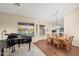 Well-lit dining room featuring a piano and a view to the backyard at 29227 N 44Th St, Cave Creek, AZ 85331