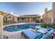 Inviting backyard with a sparkling pool, lounge chairs, and manicured landscaping at 29227 N 44Th St, Cave Creek, AZ 85331