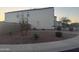 This home has a zero maintenance yard with desert landscaping, and a view of the side of the house at 3012 N 310Th Ln, Buckeye, AZ 85396