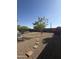 A private backyard with rock cover, a hot tub and stone paver accents at 3012 N 310Th Ln, Buckeye, AZ 85396