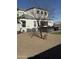 Backyard featuring a small tree, a hot tub and an outdoor fire table with seating at 3012 N 310Th Ln, Buckeye, AZ 85396