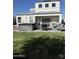 Two story home featuring a hot tub and an outdoor fire table with seating at 3012 N 310Th Ln, Buckeye, AZ 85396