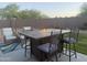 Outdoor entertaining area with a fire table, chairs and a small area of turf at 3012 N 310Th Ln, Buckeye, AZ 85396