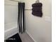 Clean, modern bathroom with shower featuring black and white curtain, gray tile floor and stacked towels at 3012 N 310Th Ln, Buckeye, AZ 85396