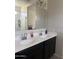 Bathroom features double sinks with modern fixtures, a large mirror, and a shower in the background at 3012 N 310Th Ln, Buckeye, AZ 85396