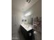 Bright bathroom featuring double sink vanity with white countertops and decorative wall storage at 3012 N 310Th Ln, Buckeye, AZ 85396