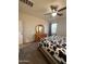 Bedroom with a cow print blanket, carpet, a dresser with a mirror, and a ceiling fan at 3012 N 310Th Ln, Buckeye, AZ 85396