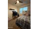 Bedroom with a tv and wooden headboard features carpet and a window for natural light at 3012 N 310Th Ln, Buckeye, AZ 85396