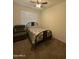 Bedroom features a ceiling fan, a large window, and neutral paint and carpet at 3012 N 310Th Ln, Buckeye, AZ 85396