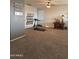 Bonus room featuring plush carpet, ceiling fan, natural light, and ample space at 3012 N 310Th Ln, Buckeye, AZ 85396