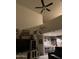 Living room with vaulted ceilings, a ceiling fan, and an entertainment center at 3012 N 310Th Ln, Buckeye, AZ 85396