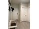Entryway features neutral paint, tile floors, a coat rack with a mirror, and white trim at 3012 N 310Th Ln, Buckeye, AZ 85396