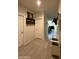 Hallway features neutral paint, tile floors, a coat rack, and leads to other rooms at 3012 N 310Th Ln, Buckeye, AZ 85396
