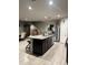 Open kitchen with a large island, stainless steel appliances, and modern tile flooring at 3012 N 310Th Ln, Buckeye, AZ 85396