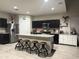 Kitchen featuring dark cabinets, stainless appliances, and a granite island with seating at 3012 N 310Th Ln, Buckeye, AZ 85396