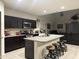 Modern kitchen features a large island with seating and stainless steel appliances at 3012 N 310Th Ln, Buckeye, AZ 85396